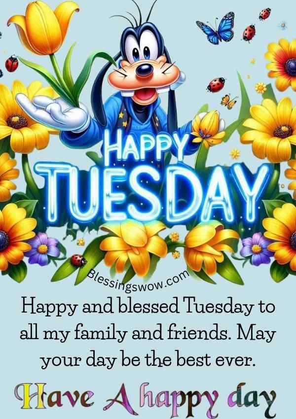 Happy Tuesday image with cartoon character and flowers wishing a blessed Tuesday for family and friends.